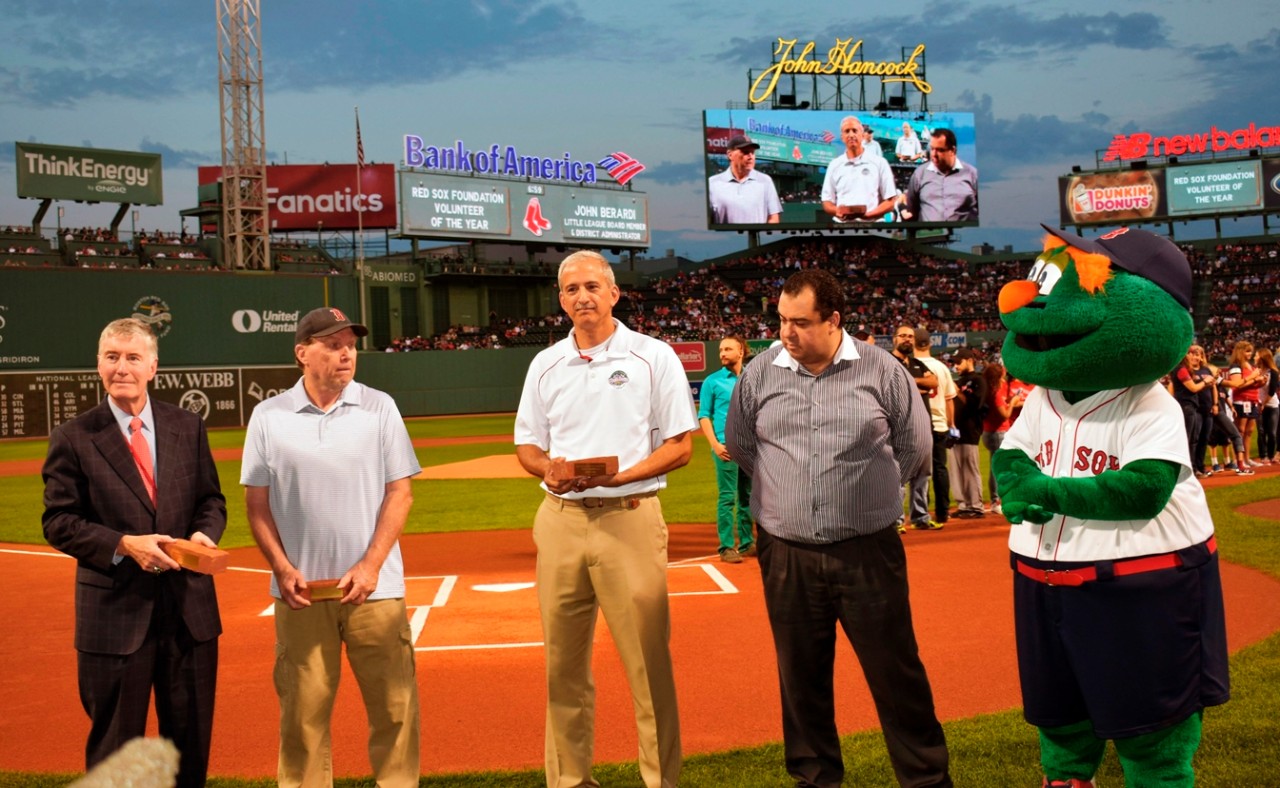 Technology Director of Applications Services John Berardi (center) was presented with a 2017 Red Sox Foundation Volunteer of the Year award at Fenway Park in August.