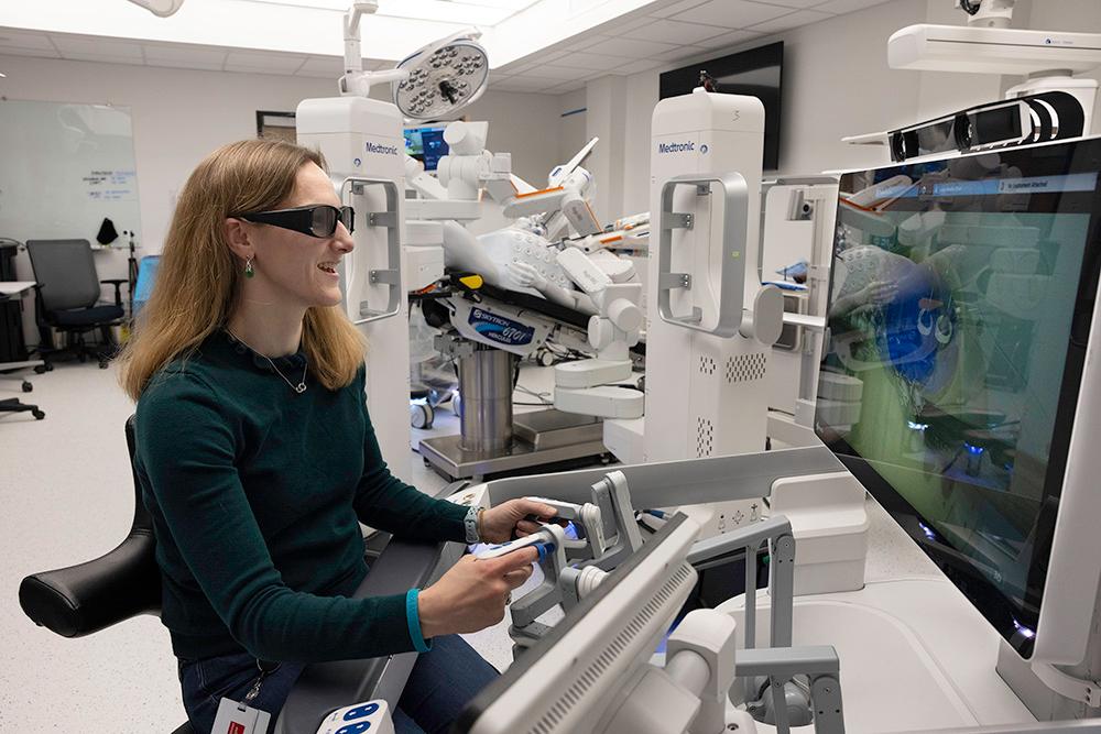 Meredith sitting at a computer wearing 3D glasses