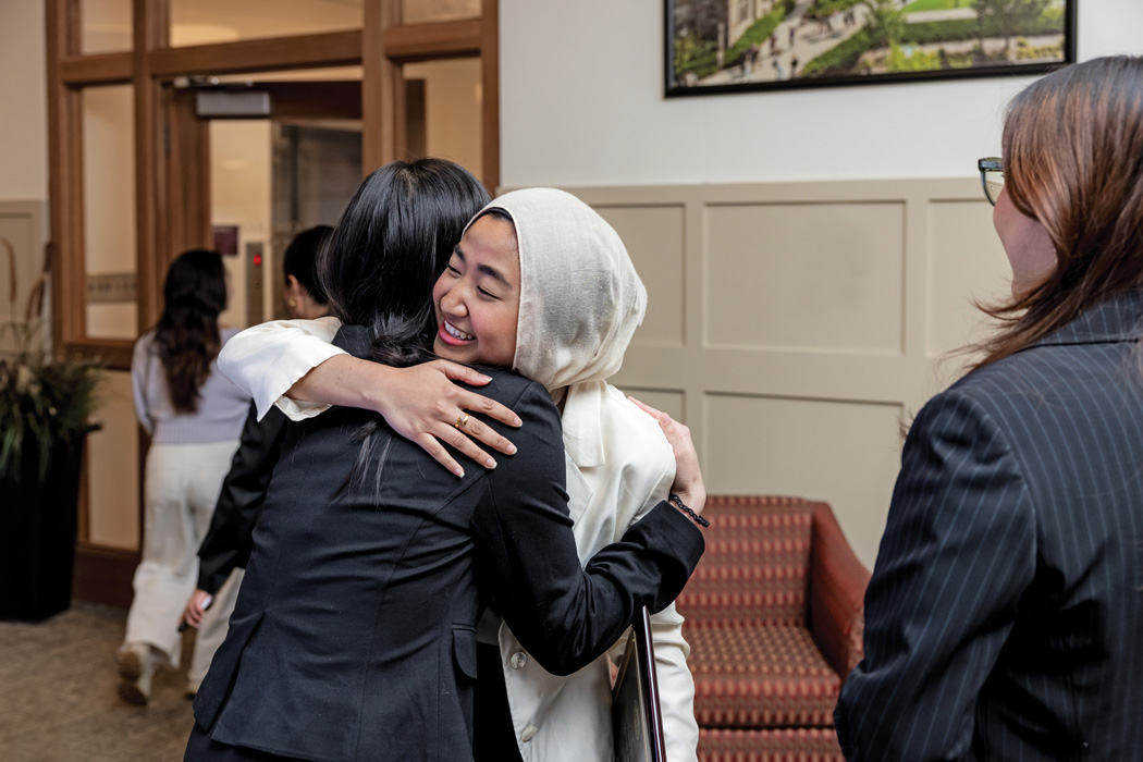 Student scholarship winner hugs a family member
