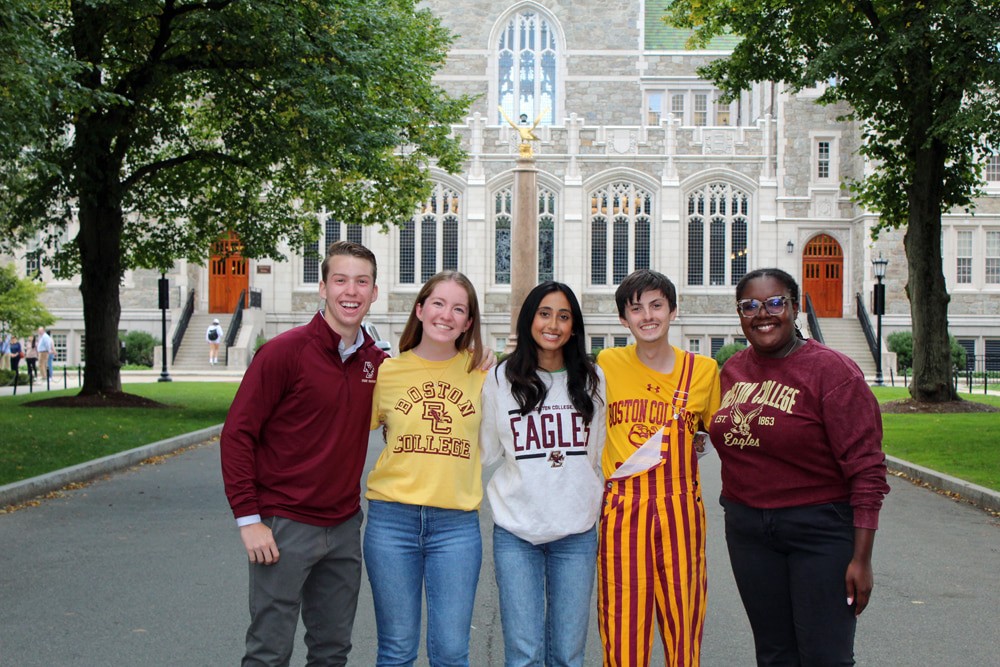 Five seniors in BC gear in front of Gasson Hall