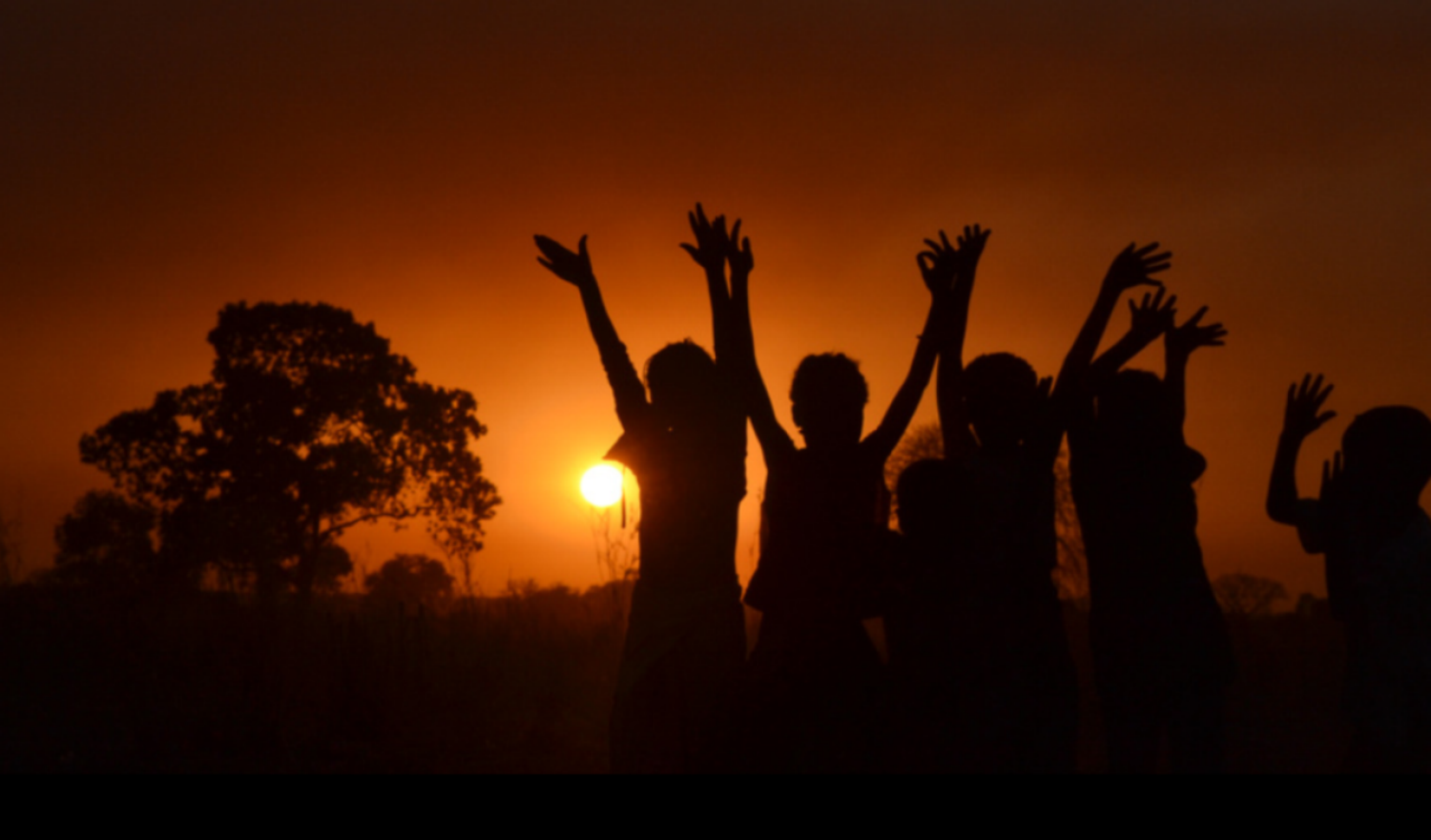Peace Corps - children silhouetted against a sunset