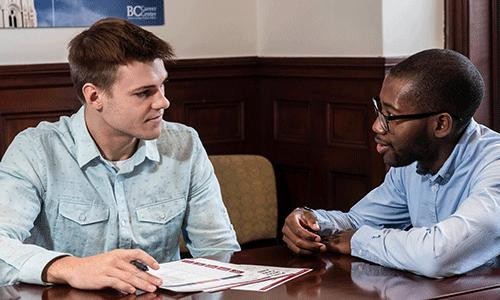 coach and student working at a table