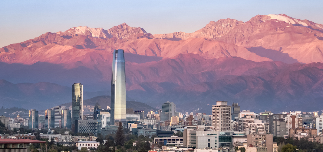 Aaerial view of Santiago skyline at sunset with Costanera skyscraper and Andes Mountains - Santiago, Chile