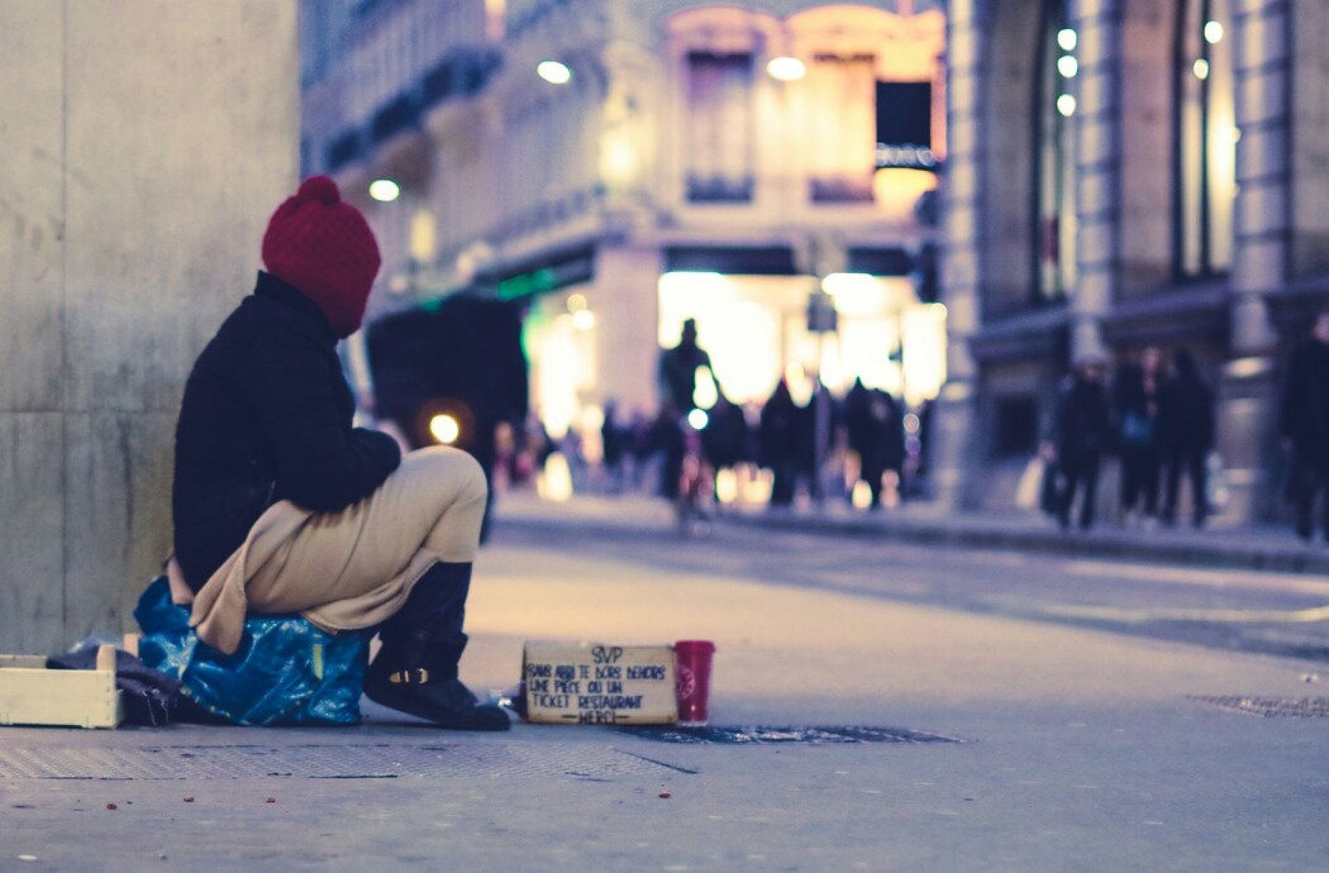 person experiencing homelessness on a city sidewalk