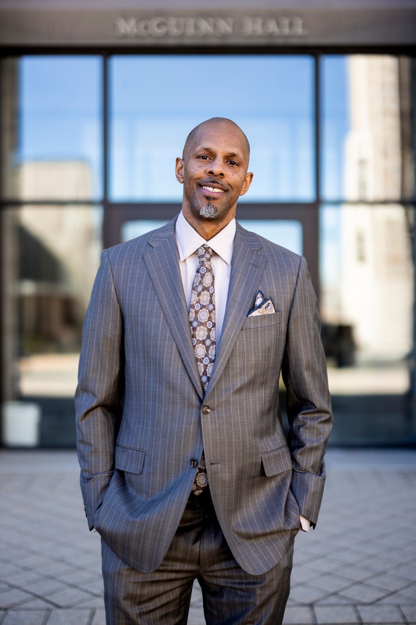 Assistant Professor Robert O. Motley Jr. poses for a photo outside of McGuinn Hall.