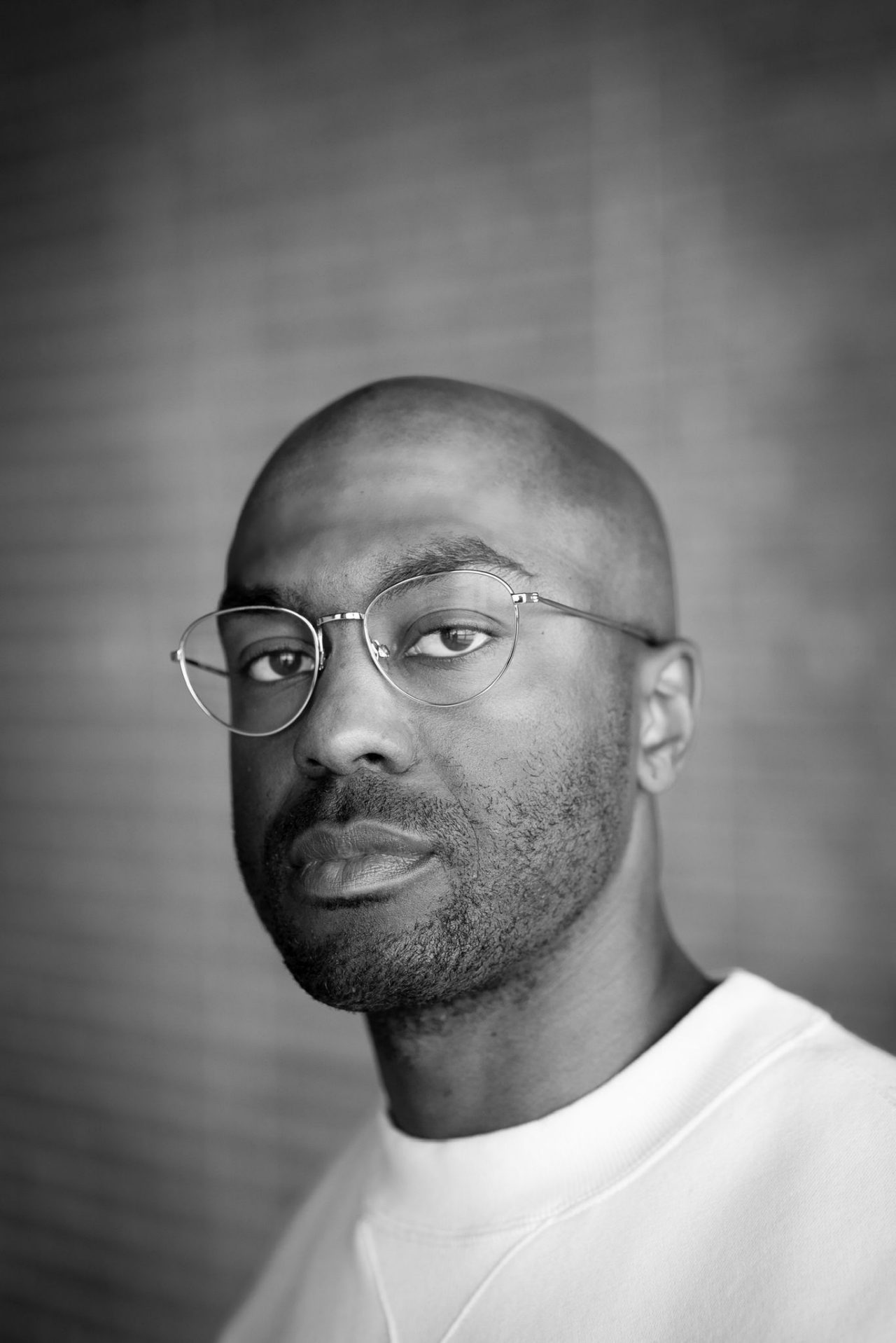 A black and white photo of Sean "Truth" Evelyn in a white T-shirt.