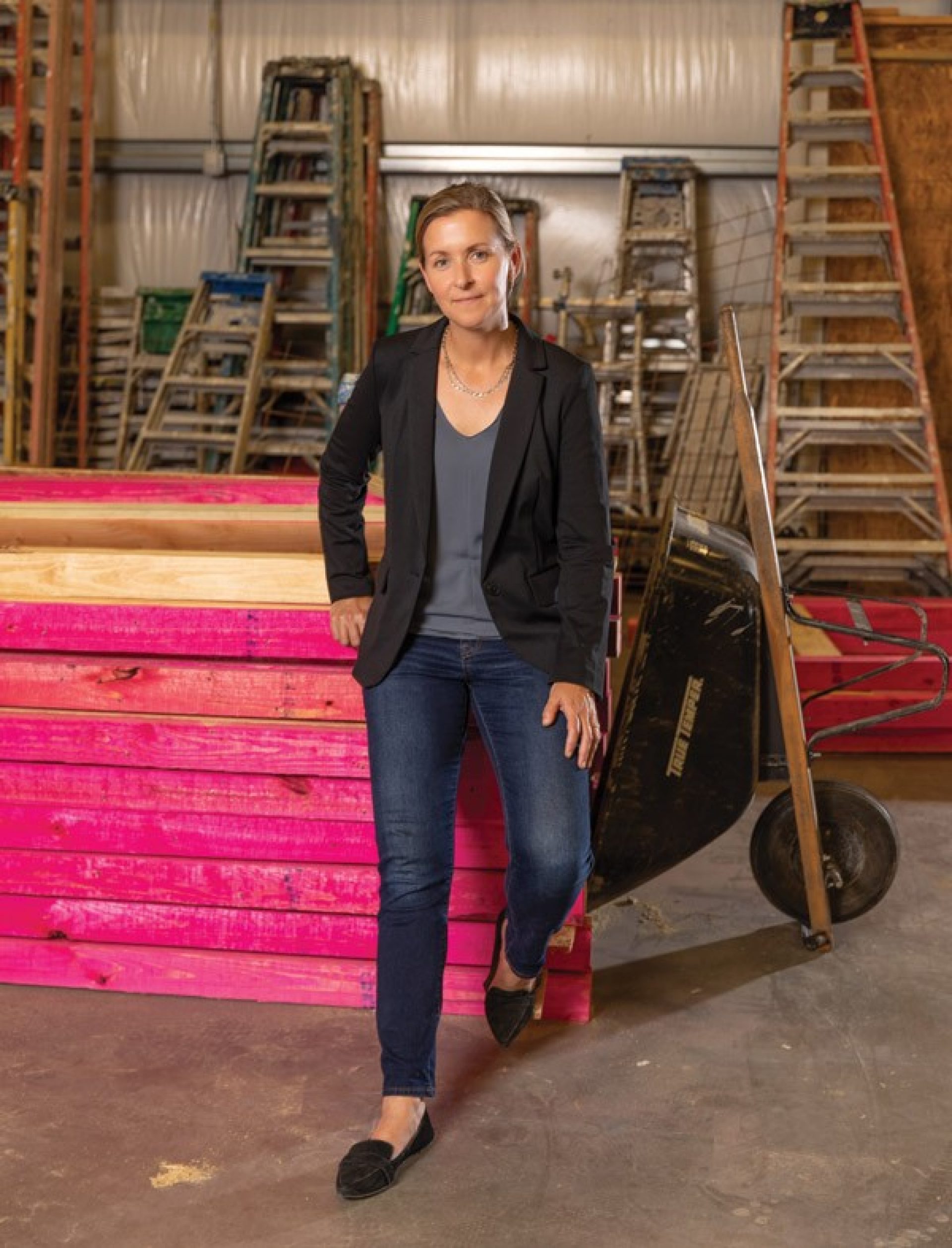 SBP cofounder Liz McCartney, photographed with equipment in a warehouse 