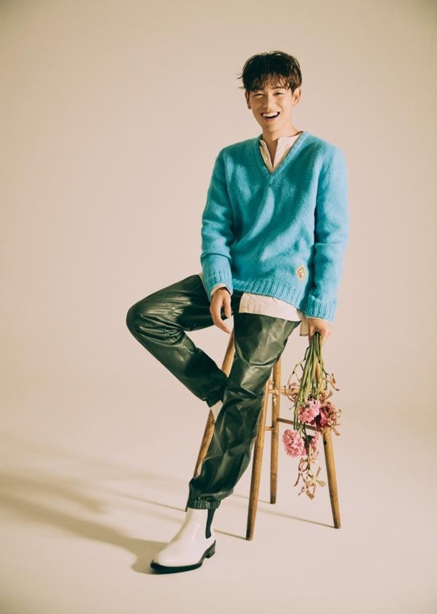 Eric Nam seated with a bouquet of flowers