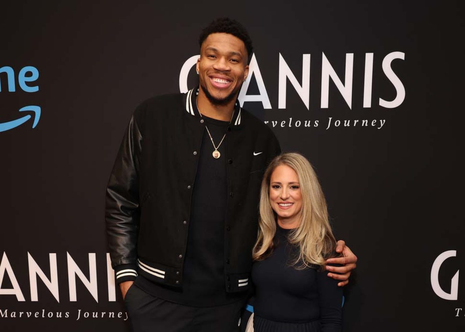 Giannis Antetokounmpo and Kristen Lappas standing together at premiere.