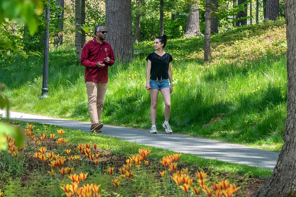 Two people walking in a wooded area
