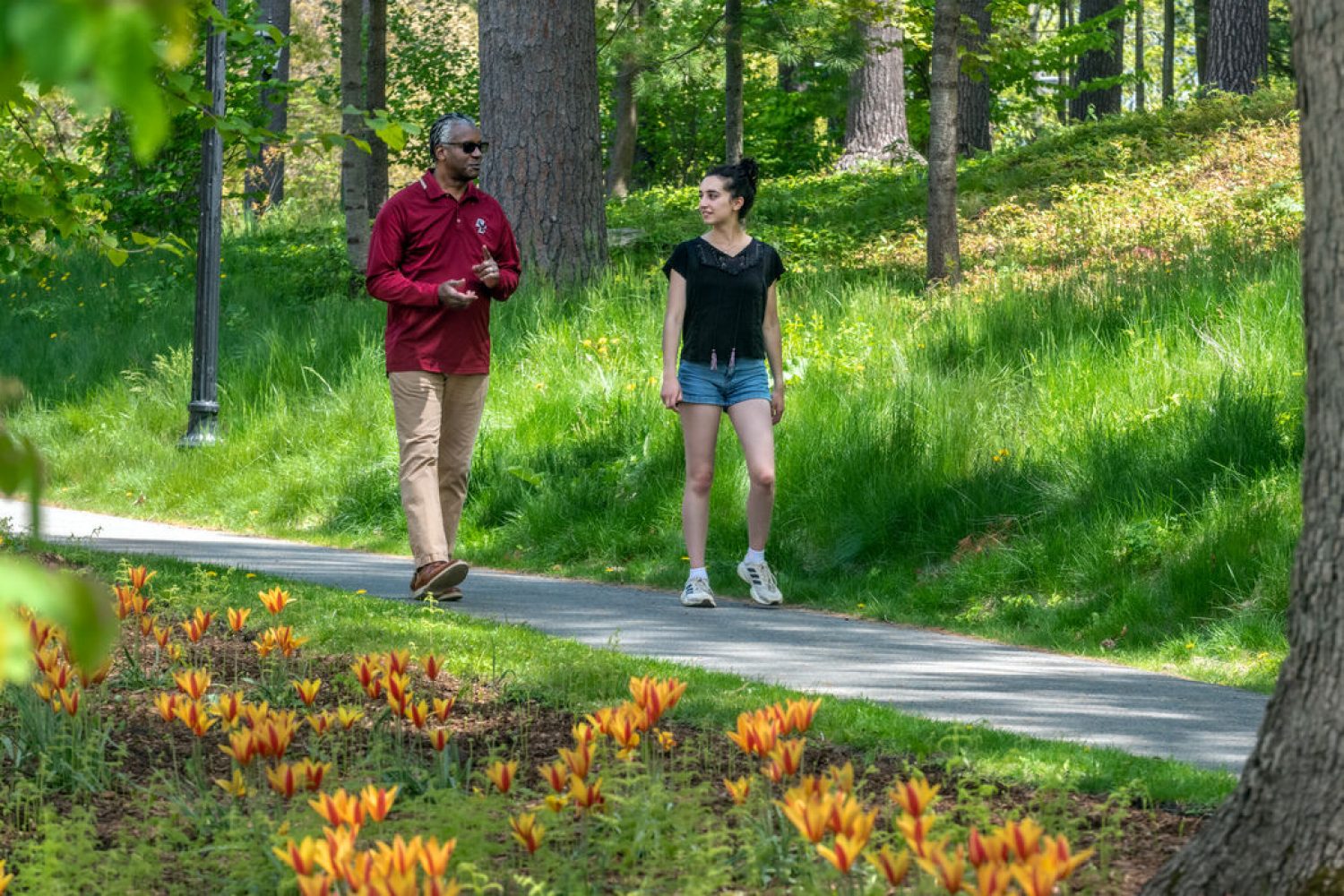 two people walking in a park