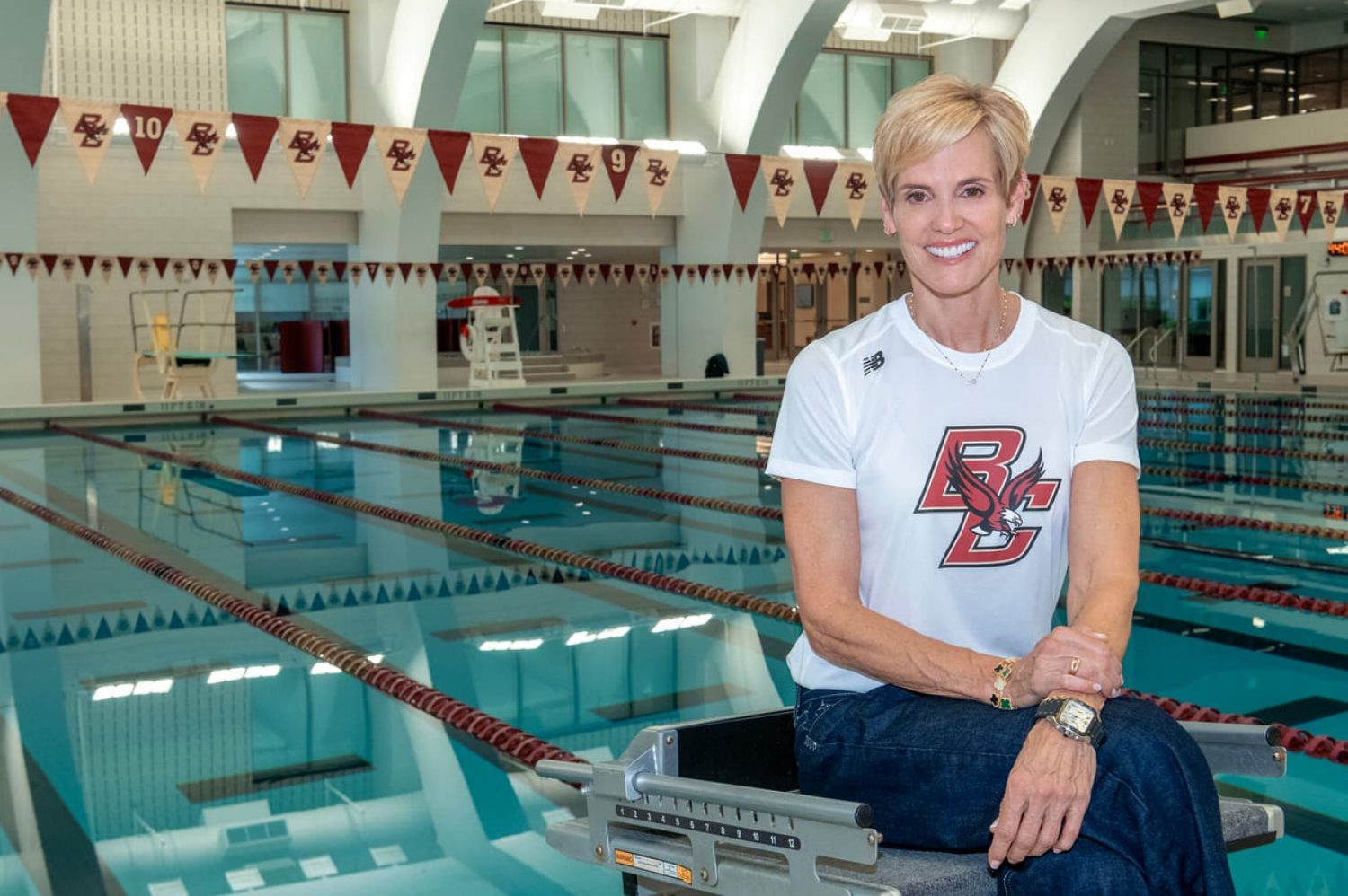 Dara Torres wearing a BC shirt and sitting beside a swimming pool