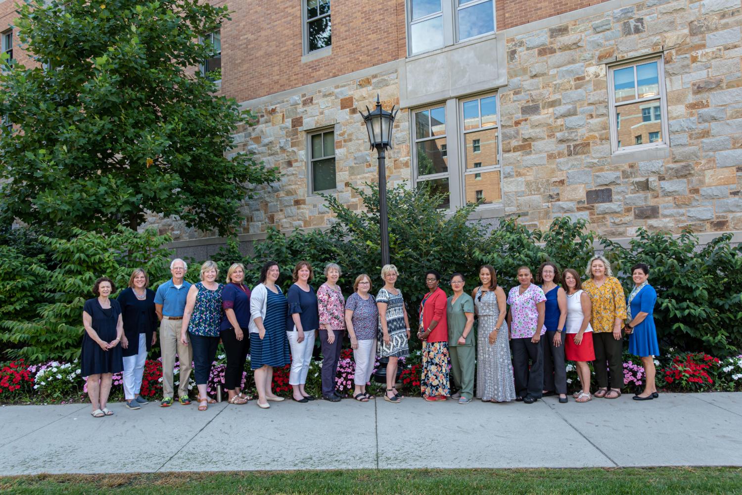 A group of staff members standing outside