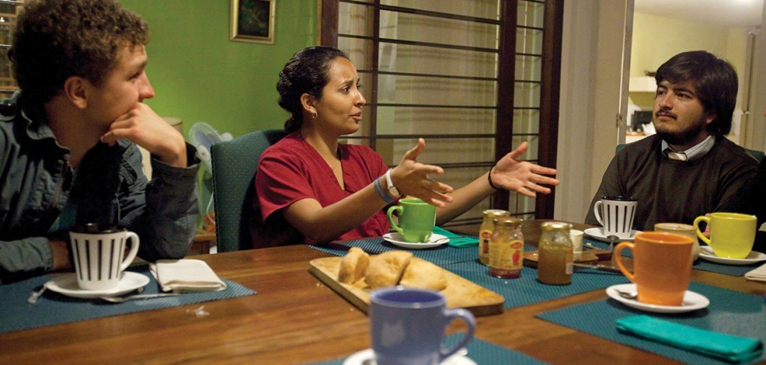 Student in Ecuador talking with host family