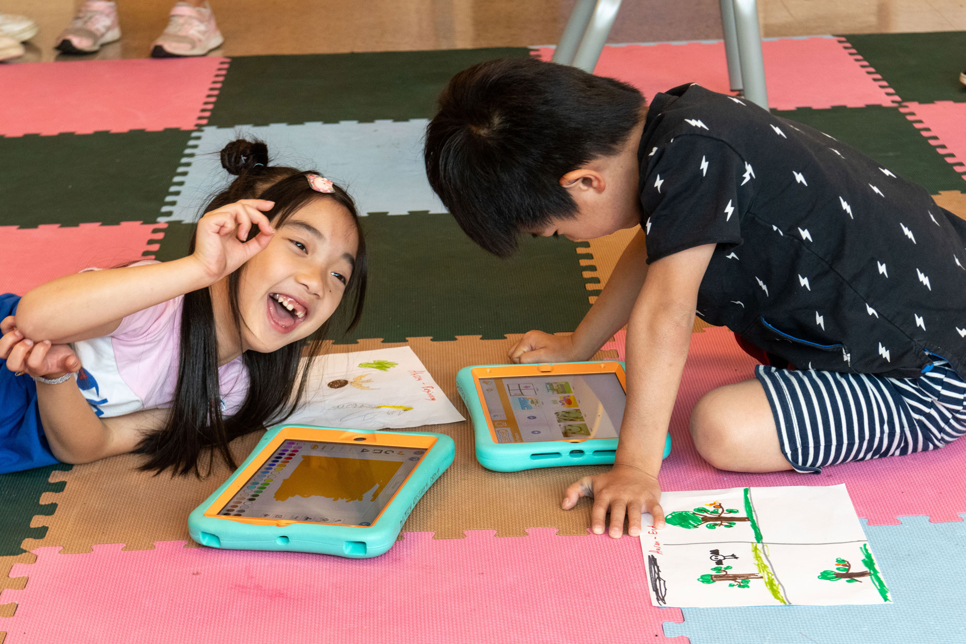 Two students working with ScratchJr on iPads at DevTech Research Group’s summer camp