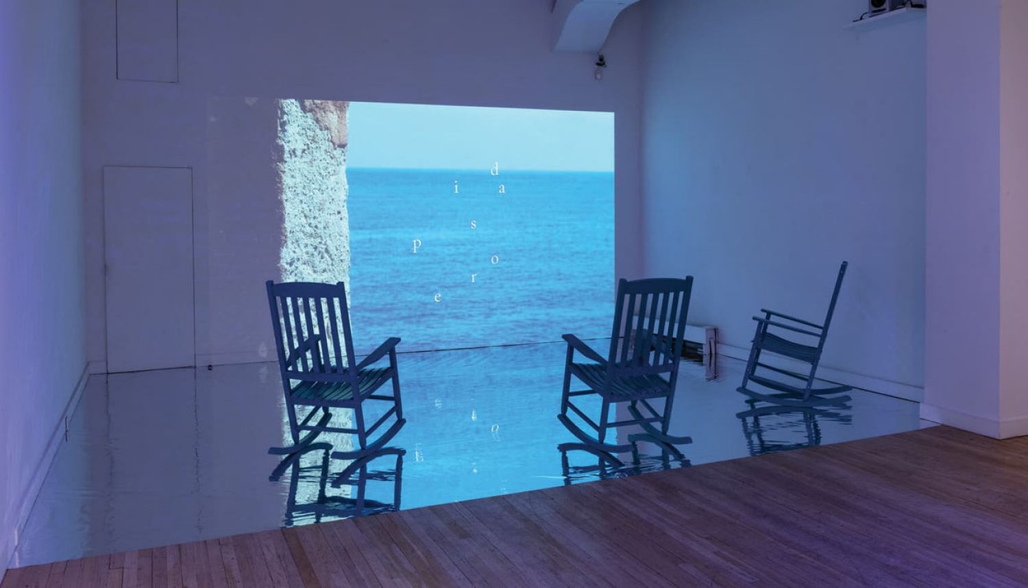 two chairs facing a doorway to the ocean