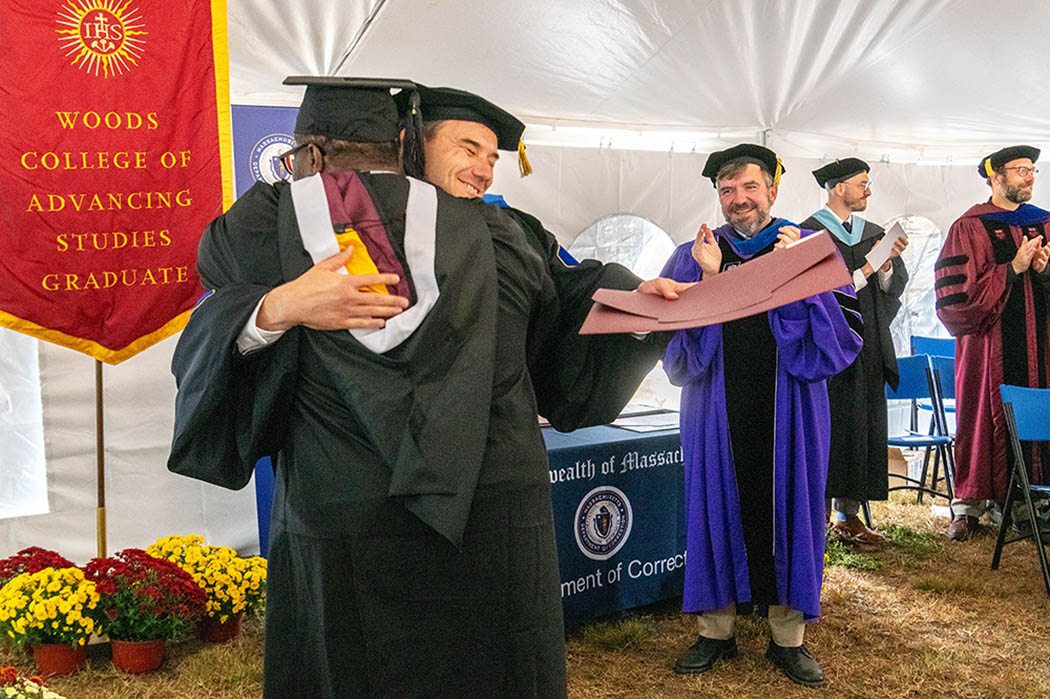 Two people hug at graduation