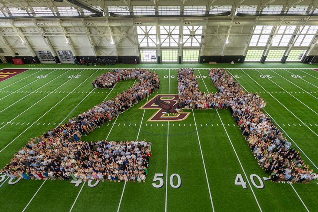 Students posing in the shape of the number 24