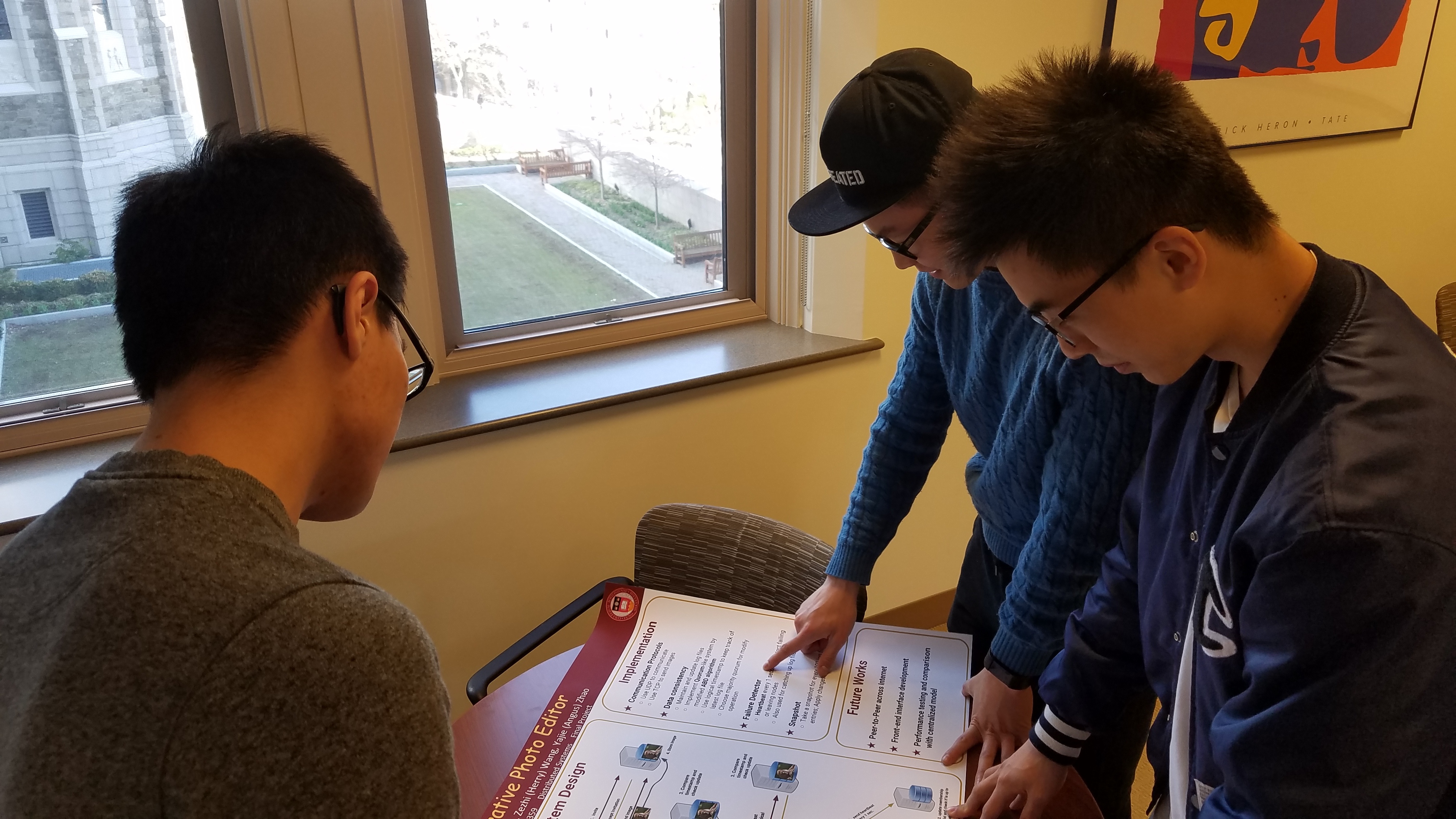 CS Students examining a poster for the upcoming Distributed Systems Poster Session